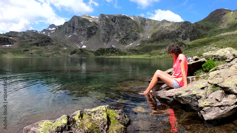 woman hiker and Lake Gentau in French Pyrenees. Mountains, valley, laggon. woman hiker and Lake Gentau in French Pyrenees. Mountains, valley, laggon.