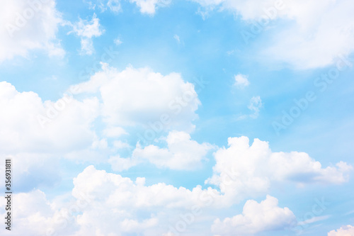 Pastel blue sky with white haep clouds