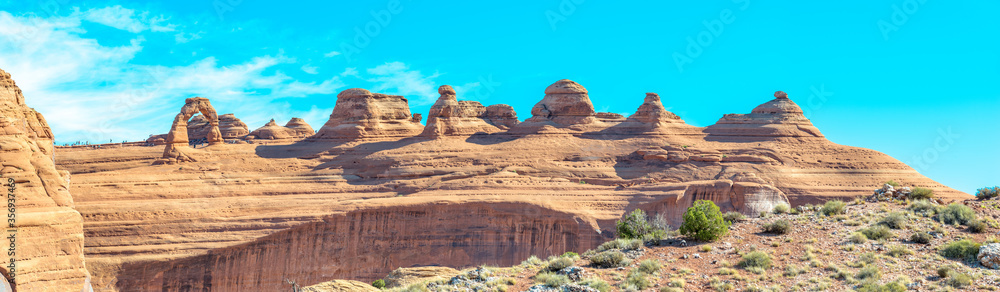 Fototapeta premium Park avenue trailhead at park scenic drive road at Arches National Utah USA. Red rock formations of Arches National Park. Canyon at the feet of the gigantic monoliths of Arches National Park.