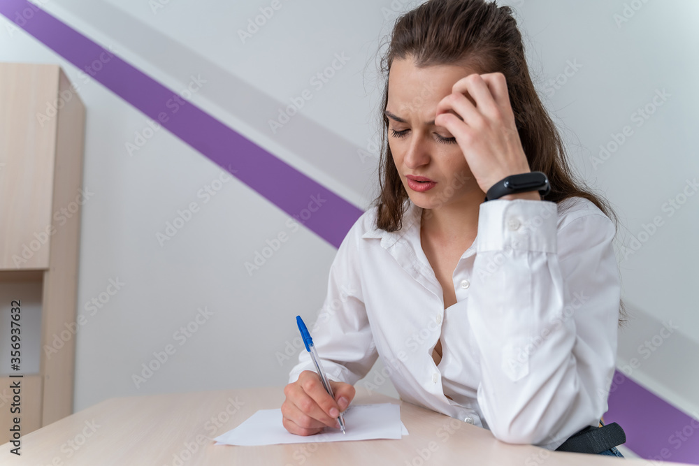 Young and beautiful businesswoman tired from work in the office. Young and beautiful businesswoman tired from work in the office.