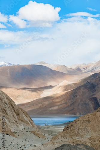 Landscape image of Pangong lake and mountains view background in Ladakh, India. Pangong is an endorheic lake in the Himalayas situated at a height of about 4,350 m. © naughtynut
