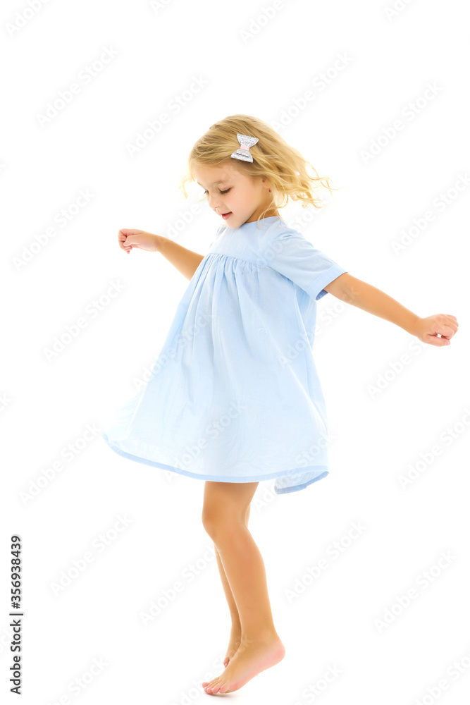 A little girl in a dress is spinning. A little girl in a dress is spinning.