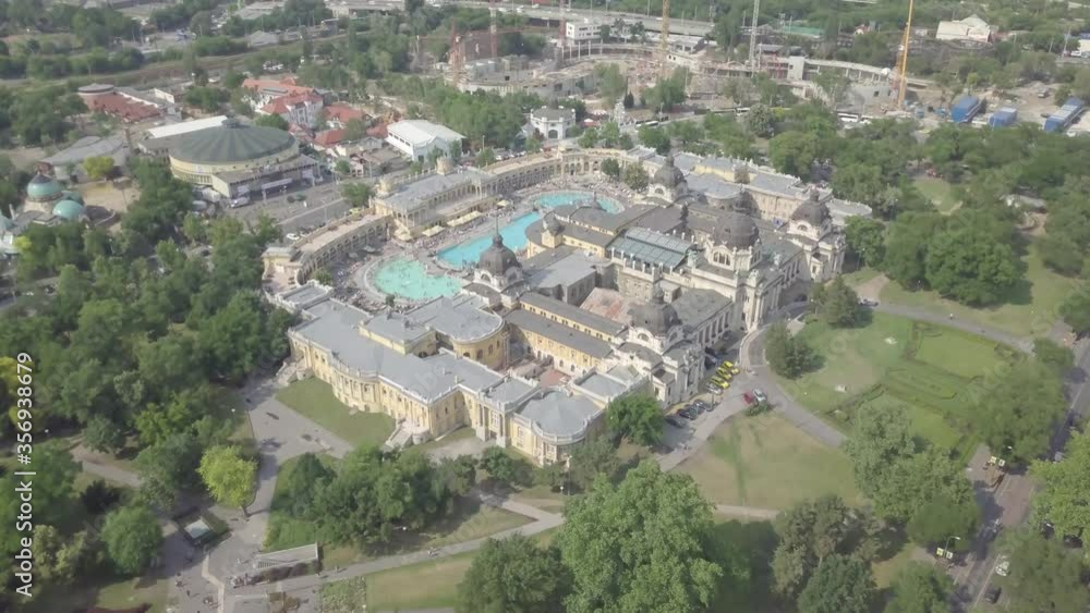 BudapestBudapest / Hungary - JUNE 01 2018: Aerial view of swimming pool Szechenyi Thermal Bath and Spa in Budapest city, Hungary. Europe. Neo baroque architecture, green park around building. Summer BudapestBudapest / Hungary - JUNE 01 2018: Aerial view of swimming pool Szechenyi Thermal Bath and Spa in Budapest city, Hungary. Europe. Neo baroque architecture, green park around building. Summer