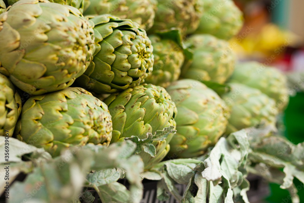 Fototapeta premium Fresh artichokes on market counter