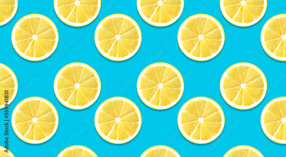 Lemon pattern on blue color background. Space for text. Summer wallpaper. Top view fruit minimal concept.