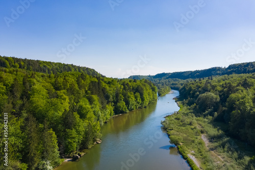 Bird view of Isar river comming from the Alps throgh a valley full of forest in spring summer time. Aerial photo of german river south of Munich. © Pablo