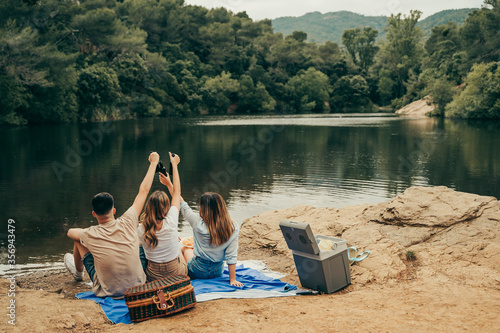 Wall Mural Friends toasting at a lake.