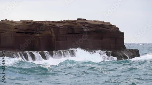 Rough seas during a thunderstorm - Powerful waves crashing on tuff shore on Ventotene Island, Italy on a cloudy day