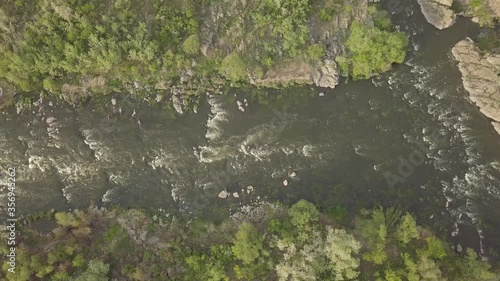 Aerial top view to rapids on Southern Bug river, surrounded by trees and grasses, Mihiia village. Ukraine. Famous place for rafting and kayaking photo