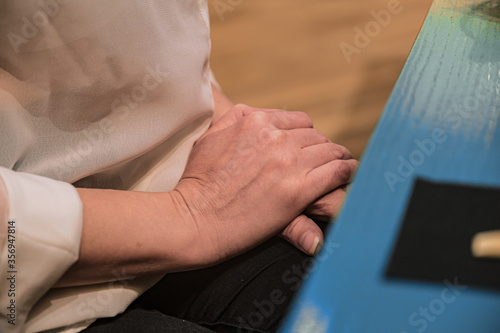 closeup of girl's hands on top of each other during negotiations. A woman hands on top of each other.