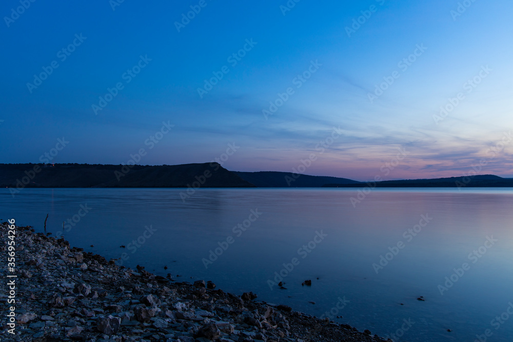 evening landscape of river nature scenic view and hill land background long exposure photography in twilight lighting