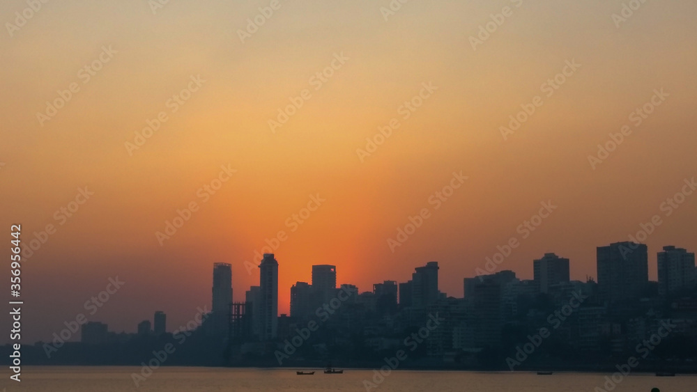 Skyline of Mumbai city at sunset with sea