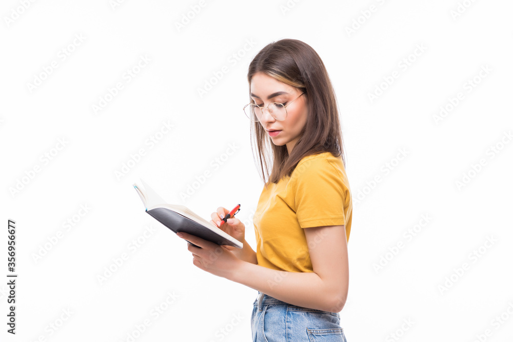 Photo of woman holding diary in hands having creative idea noticing at on paper isolated on white background Photo of woman holding diary in hands having creative idea noticing at on paper isolated on white background