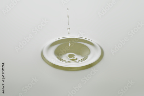 Dripping colorless oil on white background.