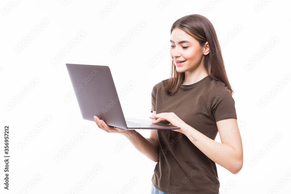 Portrait of a smiling girl holding laptop isolated on a white background and looking at camera Portrait of a smiling girl holding laptop isolated on a white background and looking at camera