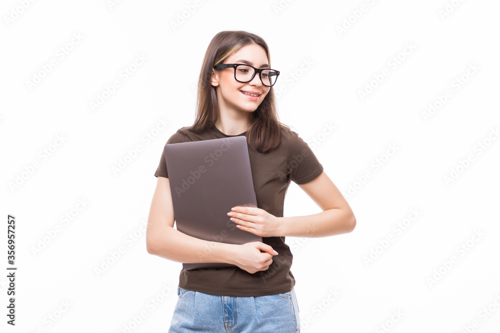 Portrait of a smiling girl holding laptop isolated on a white background and looking at camera Portrait of a smiling girl holding laptop isolated on a white background and looking at camera