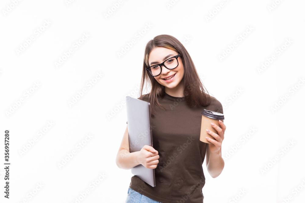 Portrait of a smiling woman holding laptop and cup of coffee over whitebackground Portrait of a smiling woman holding laptop and cup of coffee over whitebackground