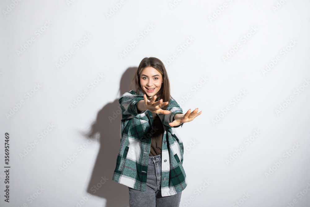 Charming handsome. Handsome young women in casual wear keeping arms crossed and smiling while standing on white background Charming handsome. Handsome young women in casual wear keeping arms crossed and smiling while standing on white background