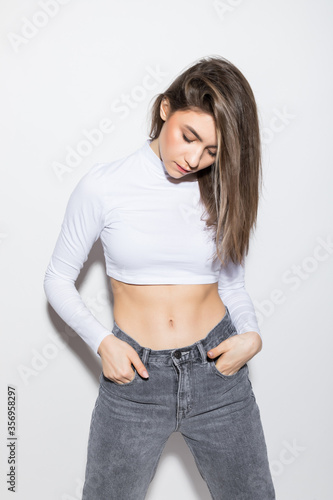 Young pretty woman isolated posing in the studio isolated on white background