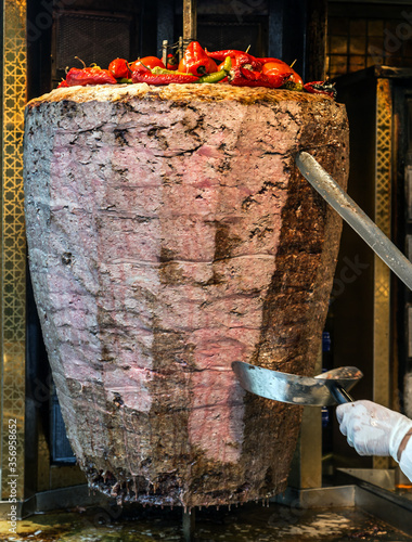 Slicing doner kebab Grilled skewered meat served shawarma