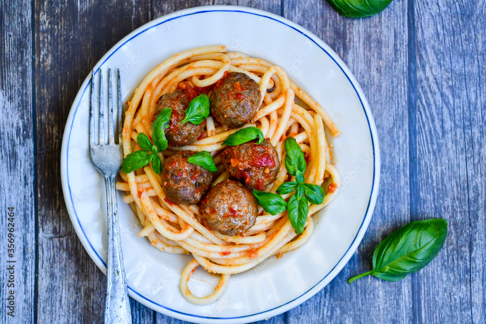 Spaghetti pasta Italian home made meal. Mediterranean food concept .Spaghetti pasta meatballs with tomato sauce, basil, herbs ,parmesan cheese Spaghetti pasta Italian home made meal. Mediterranean food concept .Spaghetti pasta meatballs with tomato sauce, basil, herbs ,parmesan cheese