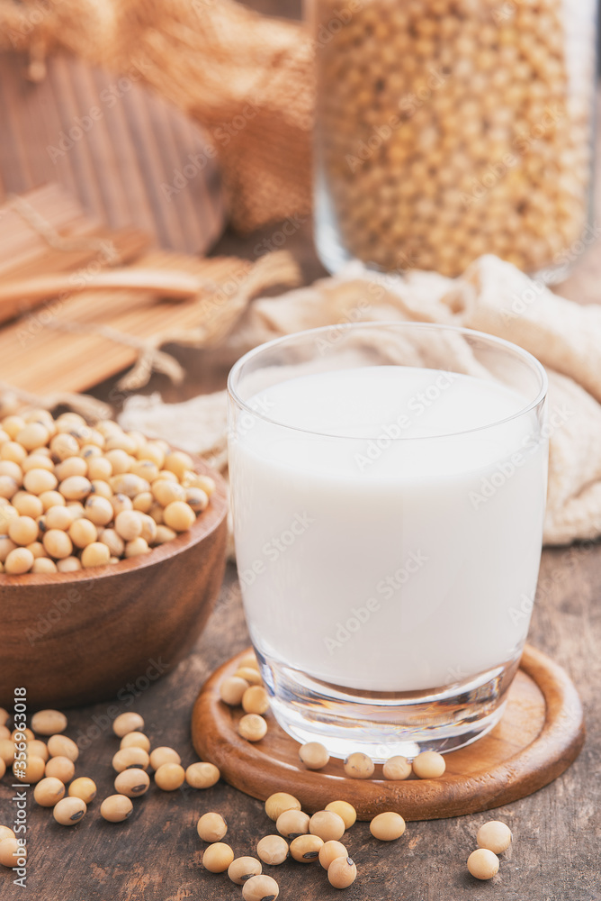 Soy milk.Soy milk on wooden background.Soy milk and soy bean on wooden background Soy milk.Soy milk on wooden background.Soy milk and soy bean on wooden background