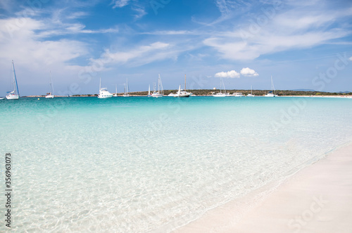 Fantastic deserted beach with transparent water and white sand  in the background the quiet bay  an ideal place to anchor the boat. Formentera  Balearic Islands  Spain