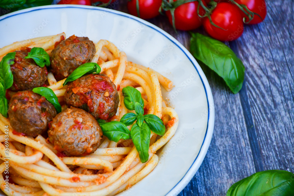 Spaghetti pasta Italian home made meal. Mediterranean food concept .Spaghetti pasta meatballs with tomato sauce, basil, herbs ,parmesan cheese Spaghetti pasta Italian home made meal. Mediterranean food concept .Spaghetti pasta meatballs with tomato sauce, basil, herbs ,parmesan cheese