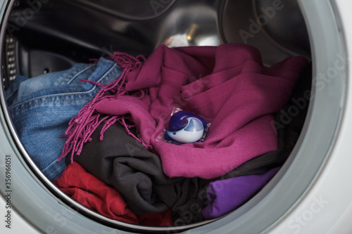 Canvas Print The capsule for washing lies in the drum of the washing machine on the laundry
