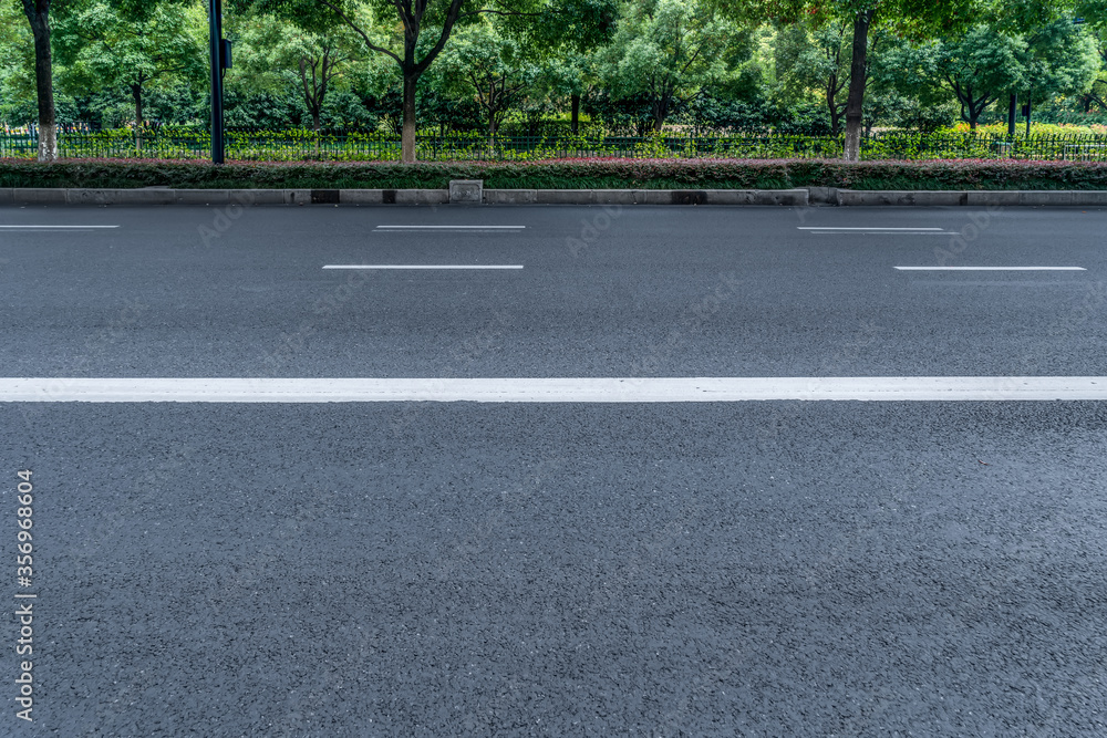 Obraz premium Asphalt road and park green forest landscape