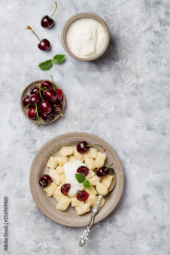 cottage cheese dumplings with sour cream and cherries