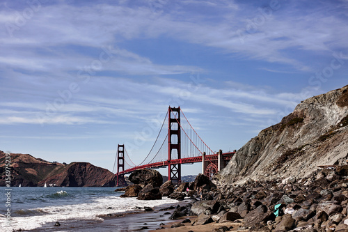 Panoramic view of famous Golden Gate from the beach on a sunny day of summer in San Francisco, California.