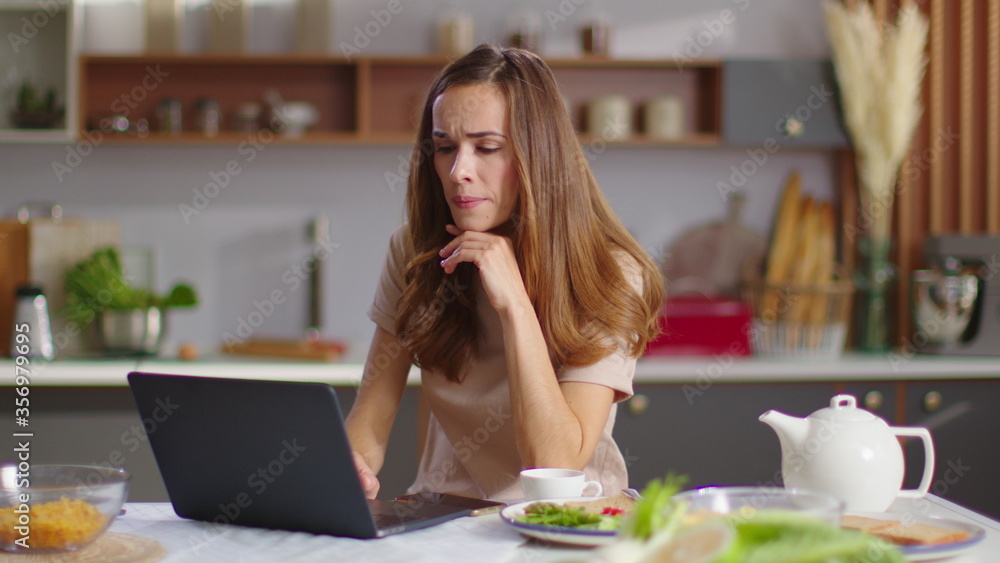 Businesswoman typing on laptop at home workplace. Woman working on laptop Businesswoman typing on laptop at home workplace. Woman working on laptop