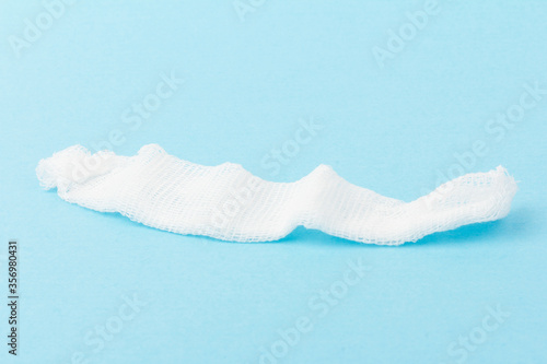 White gauze pads on  blue background. Materials for dental surgery. Close up