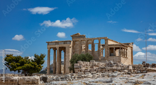 Athens, Greece. Erechtheion with Cariatides Porch on Acropolis hill, blue sky background photo