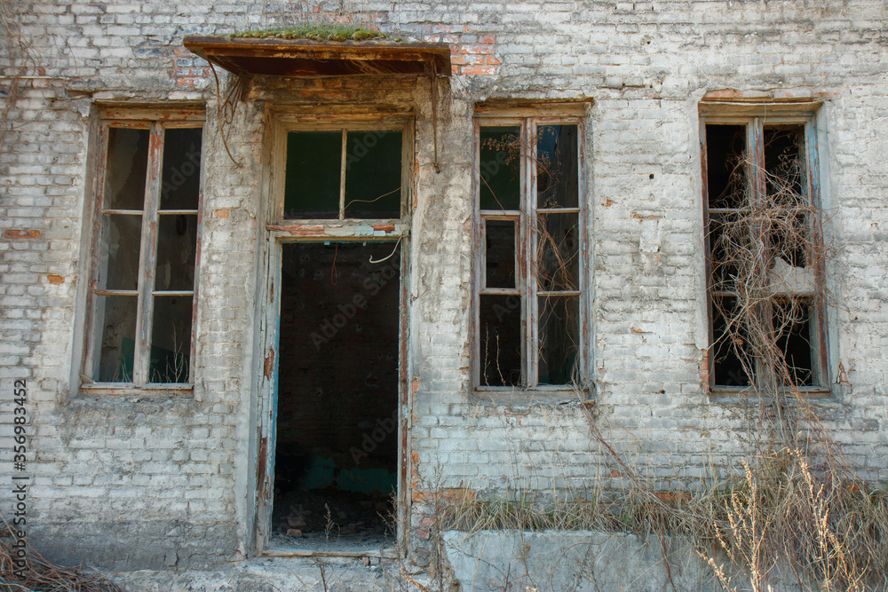 old broken window on an abandoned building
old broken window on an abandoned building