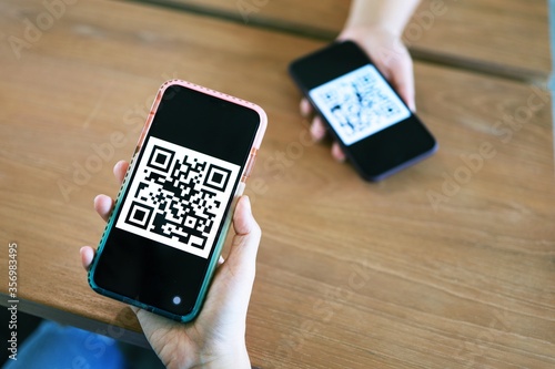 Qr code payment. Woman scanning QR code online shopping cashless technology concept.