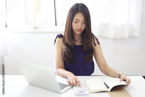 Online studying class for E learning. Smart student girl sitting at table watching lesson online and studying from home. Stay home stay safe