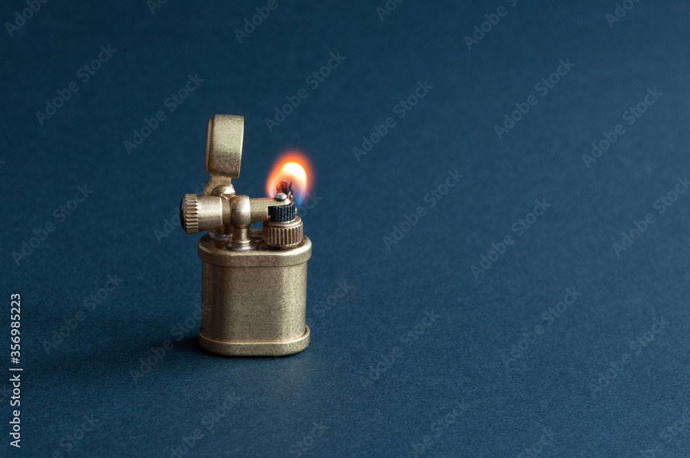 old petrol lighter. burning flame. isolated on black background. place for inscription. old petrol lighter. burning flame. isolated on black background. place for inscription.