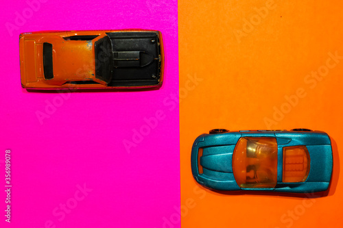 Εκτύπωση καμβά Toy cars on a high angle view with pink and orange background