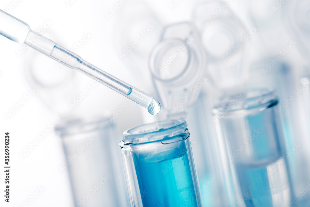 microbiological pipette in the genetic laboratory. study of a virus or vaccination. blue tinted. microbiological pipette in the genetic laboratory. study of a virus or vaccination. blue tinted.