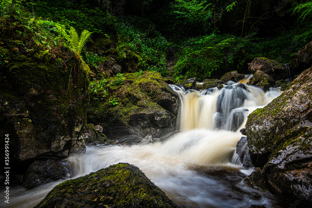 Small waterfall in the Kirk Burn running off the Campsie Fells near Lennoxtown, Scotland Small waterfall in the Kirk Burn running off the Campsie Fells near Lennoxtown, Scotland