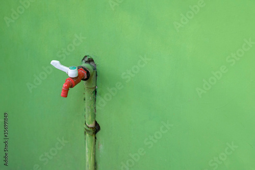 red faucet on the red wall