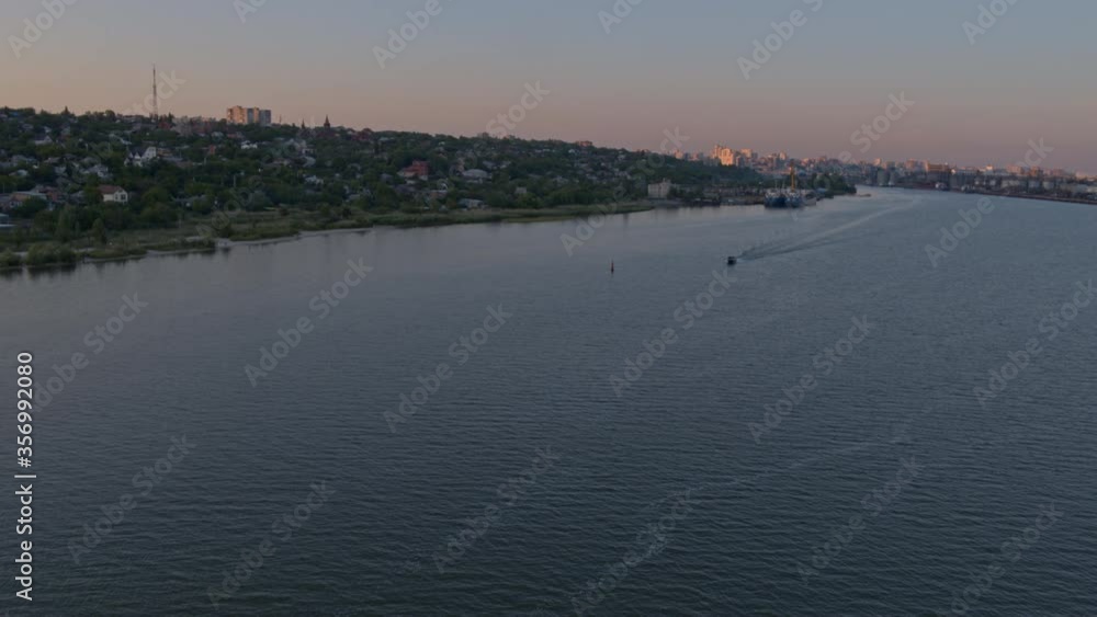 Don river with motorboat and cityscape from above, summer evening Don river with motorboat and cityscape from above, summer evening