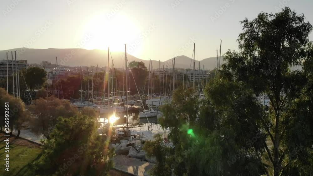 Morning in the city on the sea shore. Aerial drone bird's eye view of marina in Athens with docked yachts. Morning in the city on the sea shore. Aerial drone bird's eye view of marina in Athens with docked yachts.