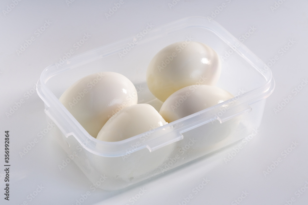 Peeled boiled chicken eggs in a plastic container Peeled boiled chicken eggs in a plastic container