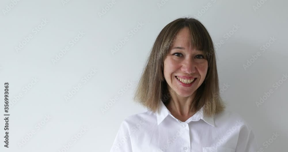 Portrait young woman looking at camera with happy emotion enjoying successful lifestyle on white background Portrait young woman looking at camera with happy emotion enjoying successful lifestyle on white background