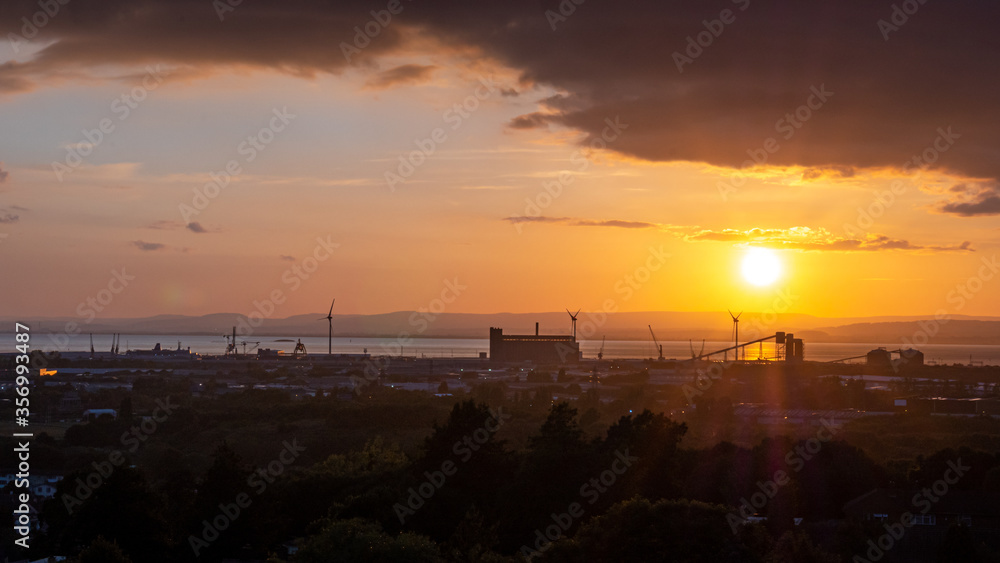 Avonmouth harbour in Bristol with windmills and in the middle of sunset with colourful clouds and the factory