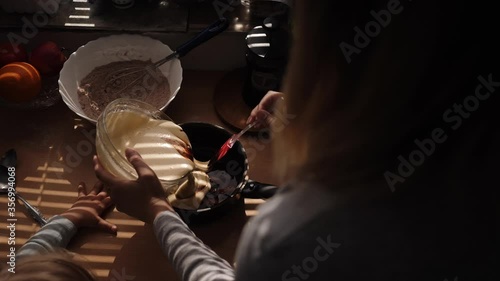 Mother and daughter preparing cookies in the kitchen