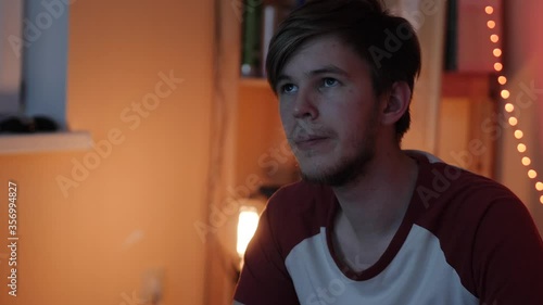 Young man watching a movie home theater projector